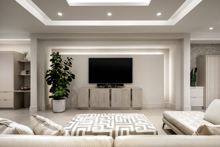 Contemporary media room with recessed lighting, neutral furnishings, and modern built-in cabinetry.