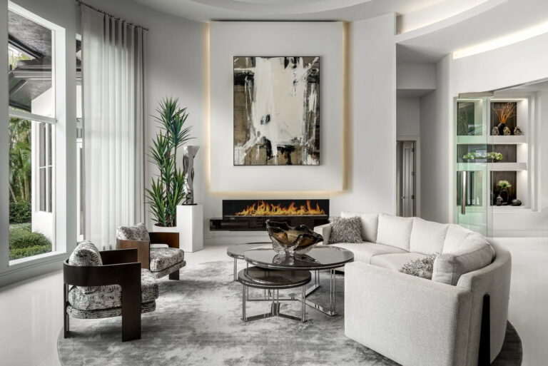 Curved white sectional sofa and modern fireplace in a luxury Boca Raton living room.