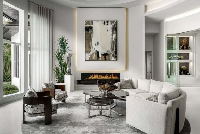Curved white sectional sofa and modern fireplace in a luxury Boca Raton living room.